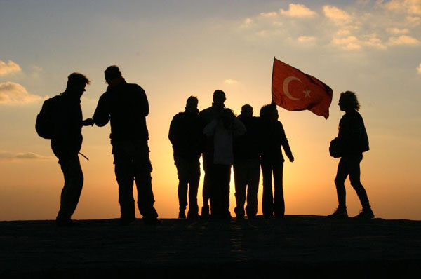 Turkish students, dawn, on 7200 ft. Mount Nemrut
